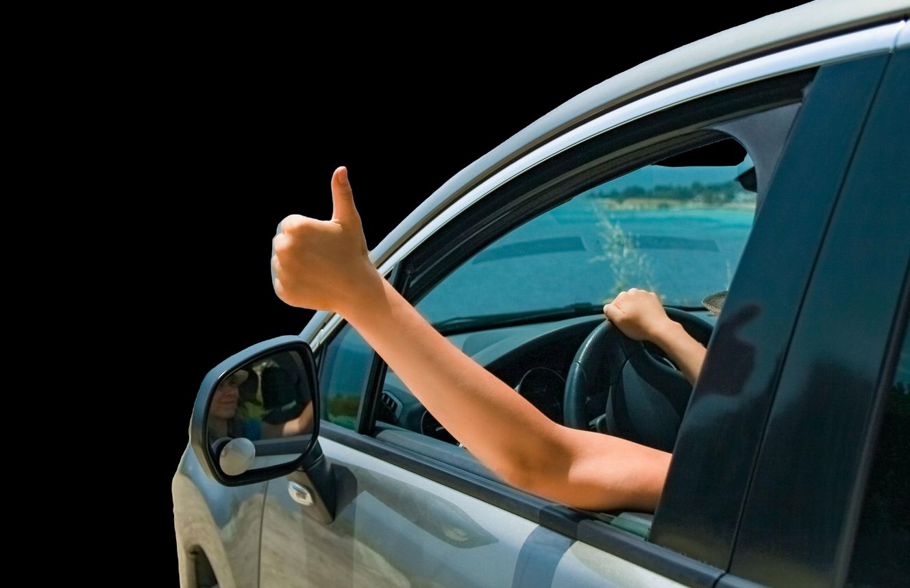 a driver gives a thumbs up out of the window